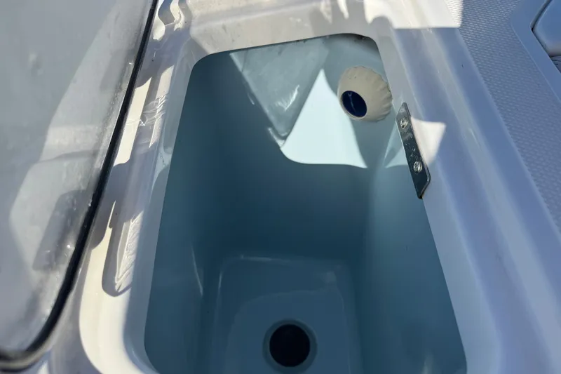 Slide: The Image of Open storage compartment on a 2021 Boston Whaler 250 Outrage boat. - 11