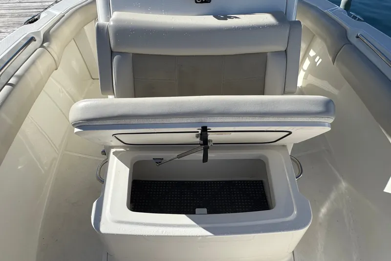 Slide: The Image of 2021 Boston Whaler 250 Outrage boat seat with open storage compartment. - 27