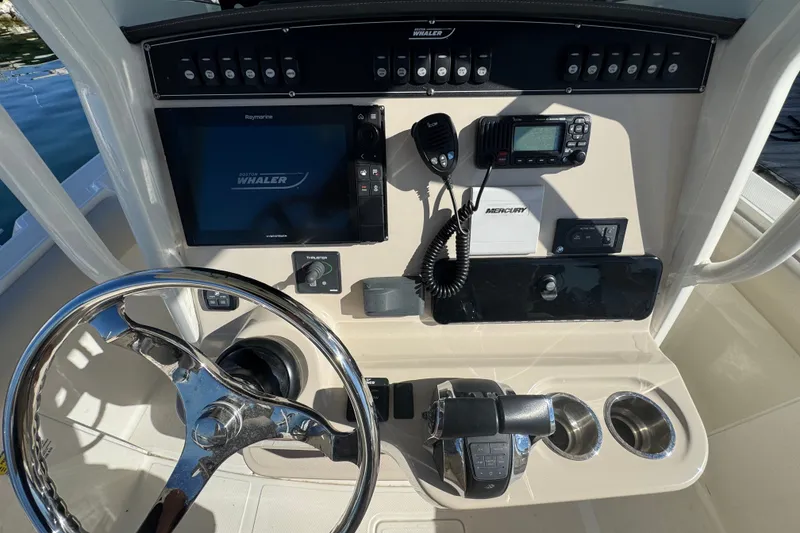 Slide: The Image of Control panel of a 2021 Boston Whaler 250 Outrage boat with steering wheel and electronics. - 17