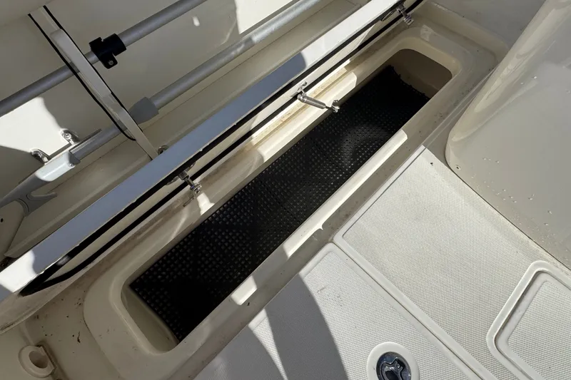 Slide: The Image of 2021 Boston Whaler 250 Outrage storage compartment with open hatch and secure fittings. - 7
