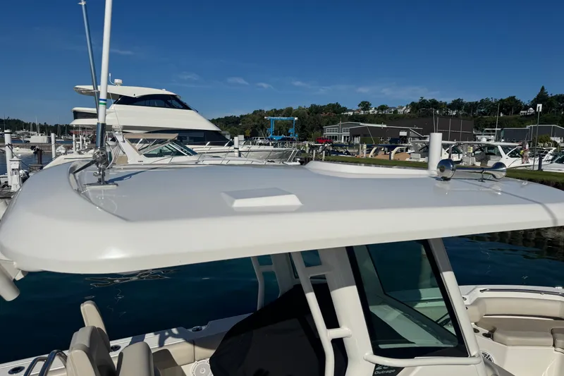 Slide: The Image of 2021 Boston Whaler 250 Outrage boat docked at marina under clear blue sky. - 5