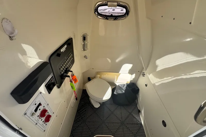Slide: The Image of Interior of 2021 Boston Whaler 250 Outrage boat with toilet and control panel. - 23