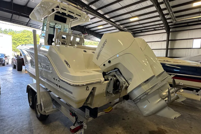Slide: The Image of 2021 Boston Whaler 250 Outrage boat with Mercury engine in a storage facility. - 33