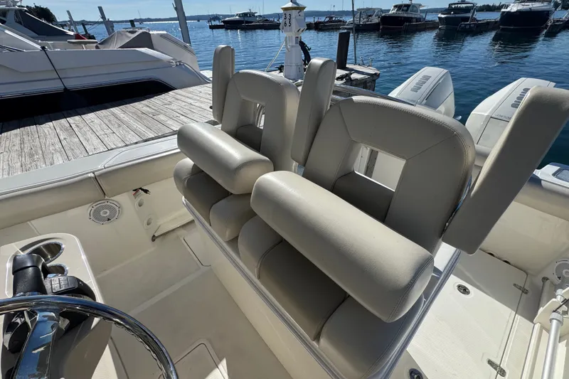 Slide: The Image of 2021 Boston Whaler 250 Outrage boat interior with dual helm seats at marina. - 18