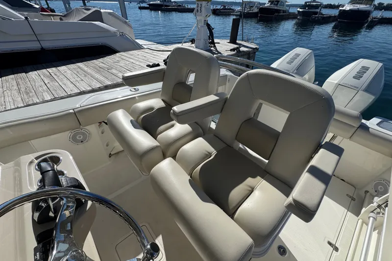 Slide: The Image of 2021 Boston Whaler 250 Outrage boat interior with dual helm seats and steering wheel. - 19