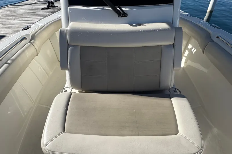 Slide: The Image of Boston Whaler 250 Outrage 2021 boat seat, docked by the water. - 28