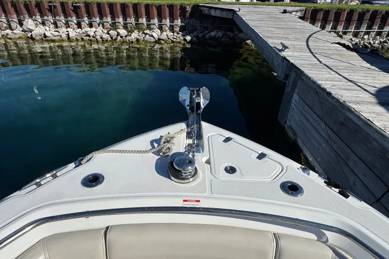 Slide: The Image of Bow view of 2021 Boston Whaler 250 Outrage docked by wooden pier. - 25