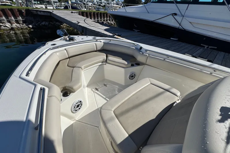 Slide: The Image of 2021 Boston Whaler 250 Outrage boat interior with cushioned seating and speakers. - 24