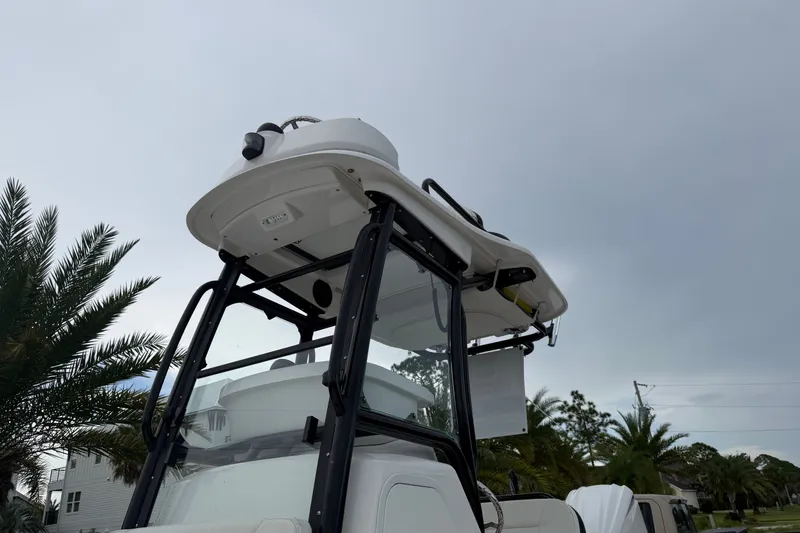 Slide: The Image of 2022 Everglades 243 Center Console boat with T-top, palm trees in background. - 15