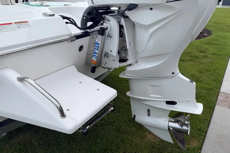 Slide: The Image of Rear view of 2022 Everglades 243 Center Console boat with outboard motor. - 13