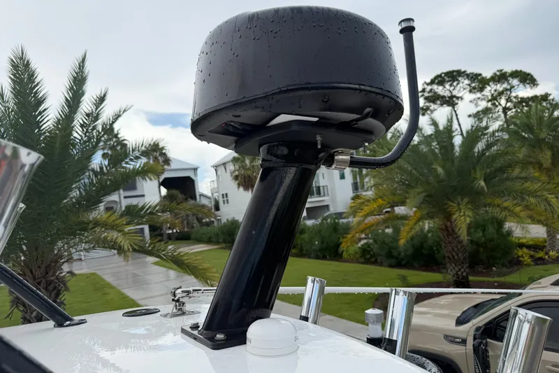 Slide: The Image of Radar equipment on 2022 Everglades 243 Center Console boat, with palm trees in background. - 17