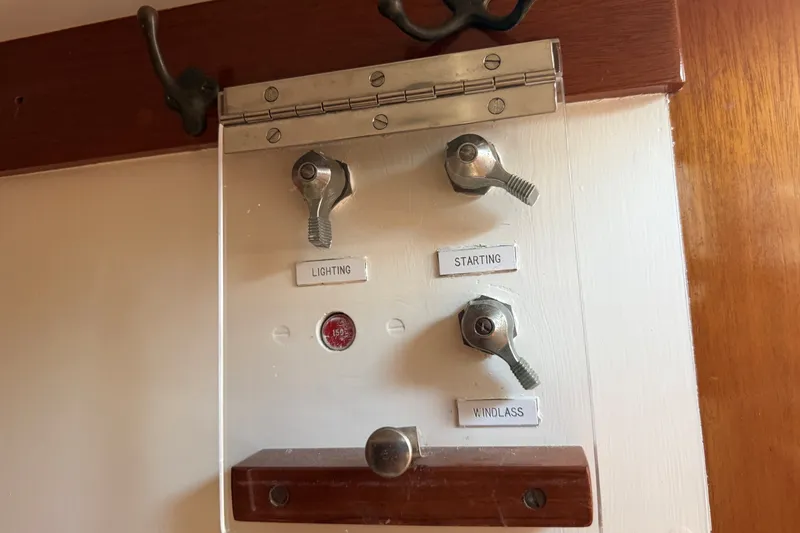Slide: The Image of Control panel on 1984 Hinckley Sou'wester 42 yacht with labeled switches for lighting, starting, and windlass. - 29