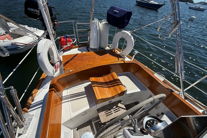 Slide: The Image of Cockpit of 1984 Hinckley Sou'wester 42 sailboat with wooden seating and nautical equipment. - 11