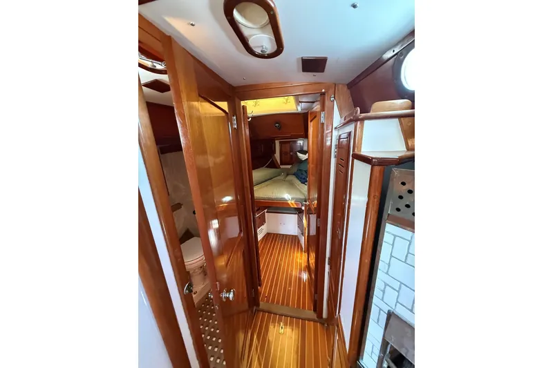Slide: The Image of Interior of 1984 Hinckley Sou'wester 42 yacht with wooden finishes and cozy cabin. - 50