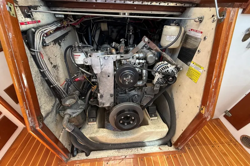 Slide: The Image of Engine compartment of a 1984 Hinckley Sou'wester 42 sailboat, showcasing mechanical components. - 58