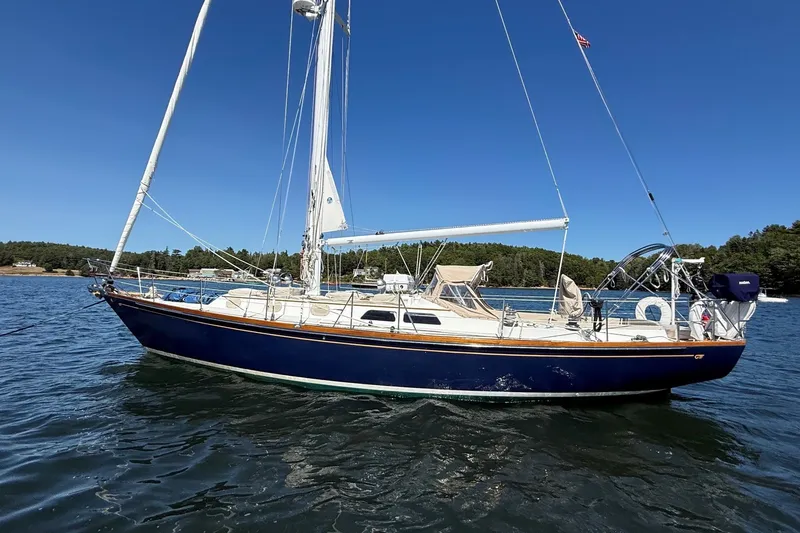 Slide: The Image of 1984 Hinckley Sou'wester 42 sailboat on calm water under clear blue sky. - 1