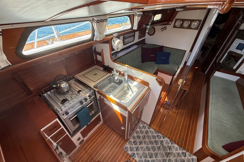Slide: The Image of Interior of 1984 Hinckley Sou'wester 42 sailboat with cozy kitchen and seating area. - 36