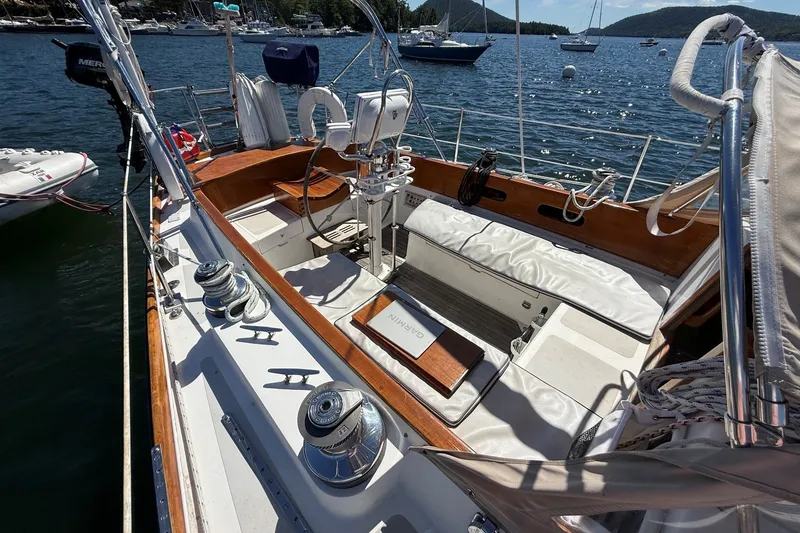 Slide: The Image of Hinckley Sou'wester 42 sailboat cockpit, 1984 model, docked on a sunny day with scenic water views. - 9