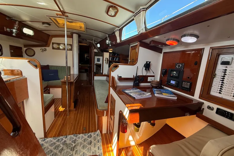 Slide: The Image of Interior of a 1984 Hinckley Sou'wester 42 sailboat, featuring wood finishes and navigation equipment. - 39