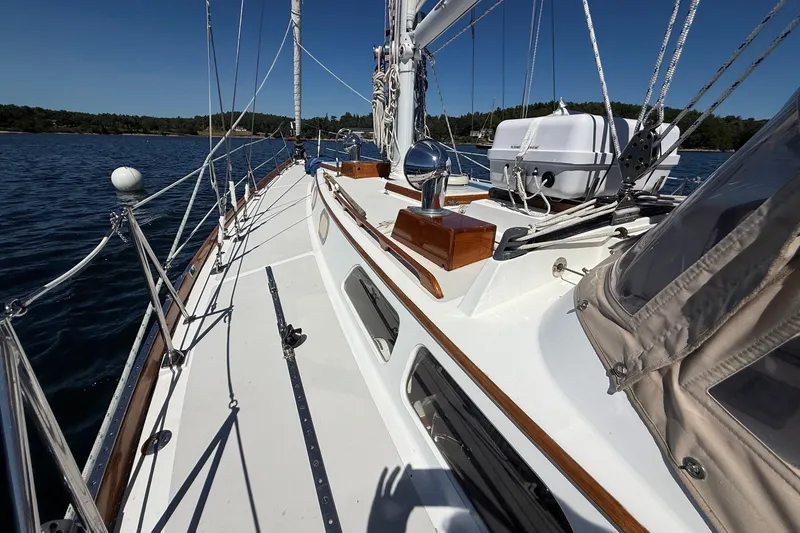 Slide: The Image of 1984 Hinckley Sou'wester 42 sailboat deck with clear skies and calm waters. - 18