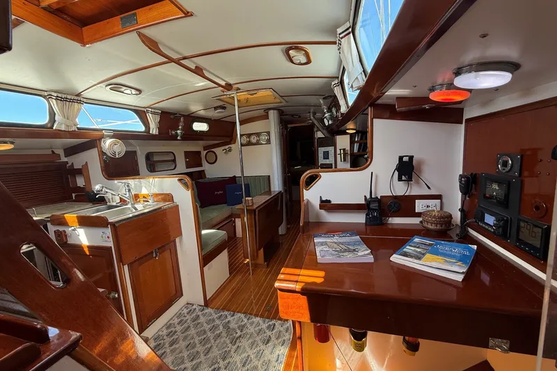 Slide: The Image of Interior of 1984 Hinckley Sou'wester 42 sailboat, featuring wood finishes and navigation equipment. - 40
