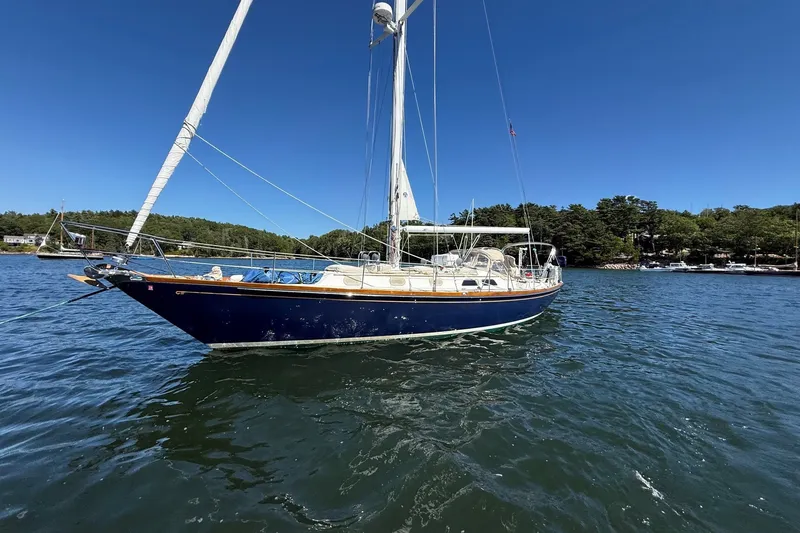 Slide: The Image of 1984 Hinckley Sou'wester 42 sailboat on calm water under clear blue sky. - 7