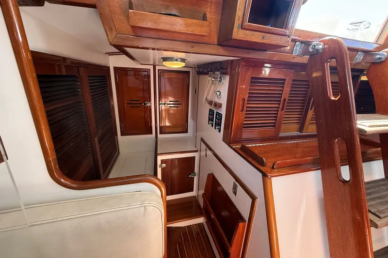 Slide: The Image of Interior of 1984 Hinckley Sou'wester 42 sailboat with wooden cabinetry and stairs. - 43