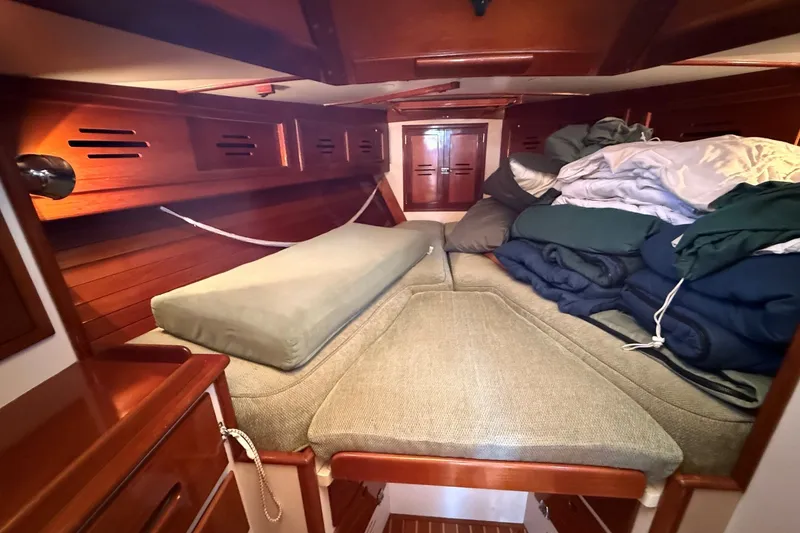 Slide: The Image of Cozy cabin interior of 1984 Hinckley Sou'wester 42 sailboat with wooden finish and bedding. - 49
