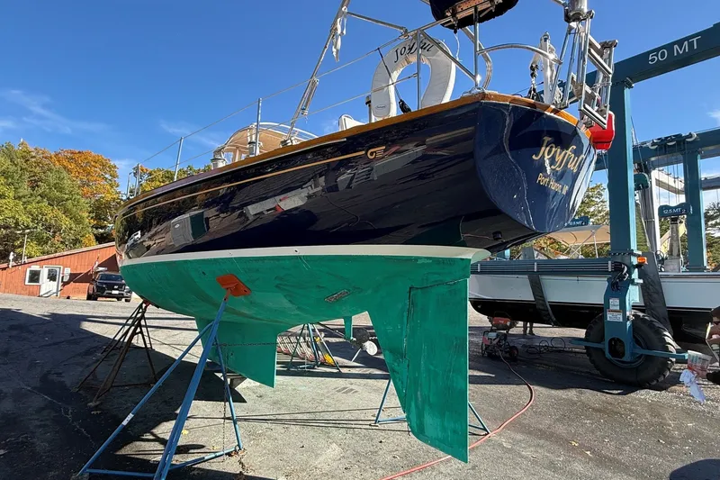 Slide: The Image of 1984 Hinckley Sou'wester 42 sailboat on stands, undergoing maintenance in a boatyard. - 59