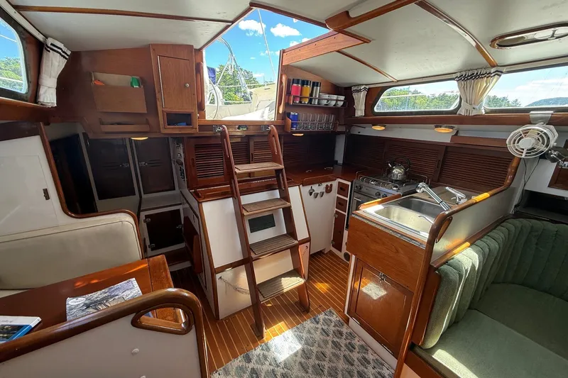 Slide: The Image of Interior of 1984 Hinckley Sou'wester 42 sailboat with wooden cabinetry and compact kitchen. - 38