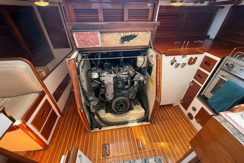 Slide: The Image of Engine compartment of a 1984 Hinckley Sou'wester 42 sailboat, showcasing detailed interior craftsmanship. - 57