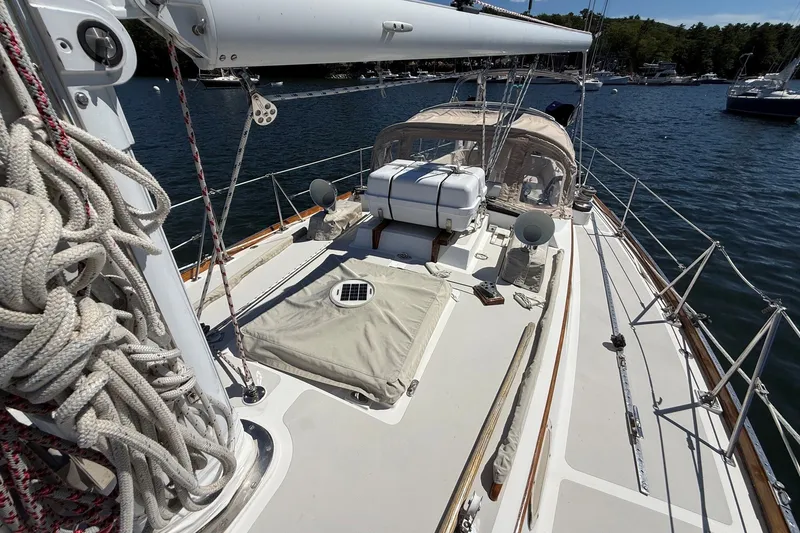 Slide: The Image of 1984 Hinckley Sou'wester 42 sailboat deck with ropes and equipment on a sunny day. - 24
