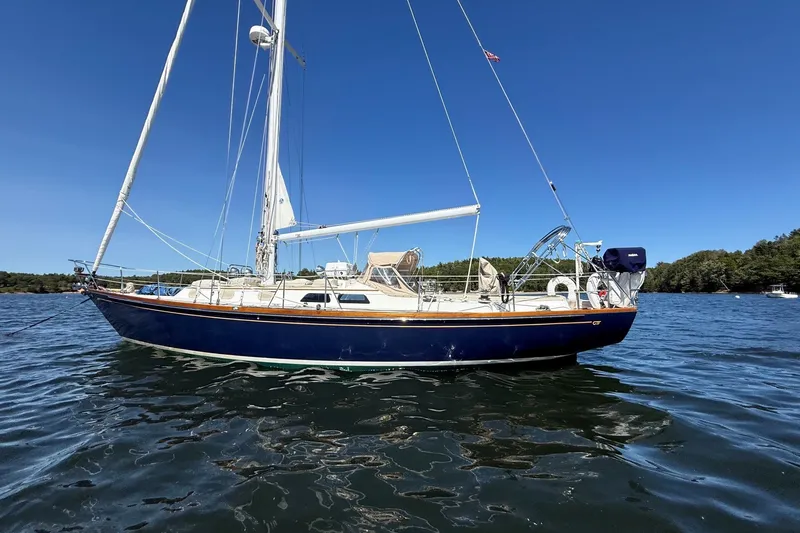 Slide: The Image of 1984 Hinckley Sou'wester 42 sailboat on calm water under clear blue sky. - 3