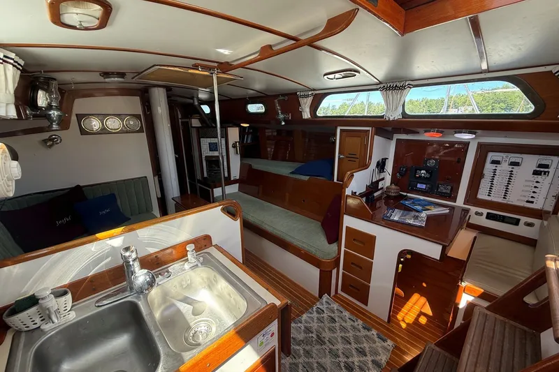 Slide: The Image of Interior of 1984 Hinckley Sou'wester 42 sailboat, featuring cozy seating and navigation area. - 37