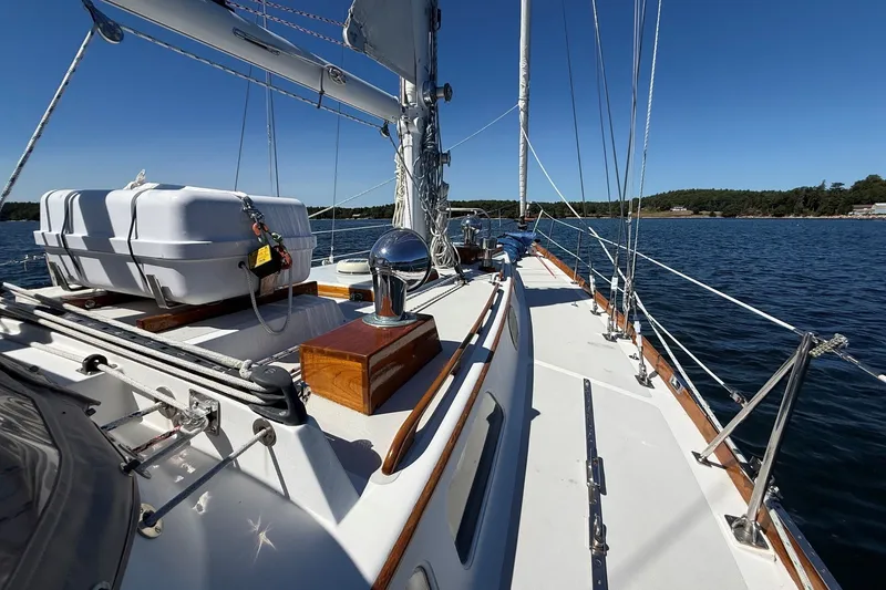Slide: The Image of 1984 Hinckley Sou'wester 42 sailboat deck with clear blue skies and calm waters. - 14