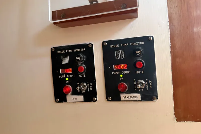Slide: The Image of Bilge pump monitors on a 1984 Hinckley Sou'wester 42 yacht, displaying pump counts. - 32