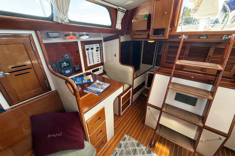 Slide: The Image of 1984 Hinckley Sou'wester 42 yacht interior with wooden cabinetry and navigation equipment. - 41