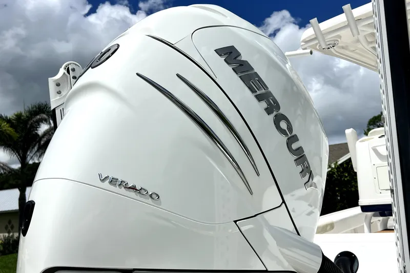 Slide: The Image of 2020 Caymas 26 HB with Mercury Verado engine, showcasing sleek design under cloudy sky. - 10