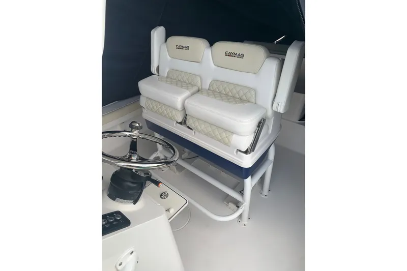 Slide: The Image of 2020 Caymas 26 HB boat interior with dual cushioned seats and steering wheel. - 3