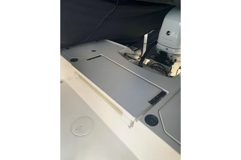 Slide: The Image of 2020 Caymas 26 HB boat interior with storage compartments and engine view. - 9