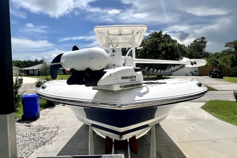 Slide: The Image of 2020 Caymas 26 HB boat with Minn Kota Terrova motor on driveway under blue sky. - 7
