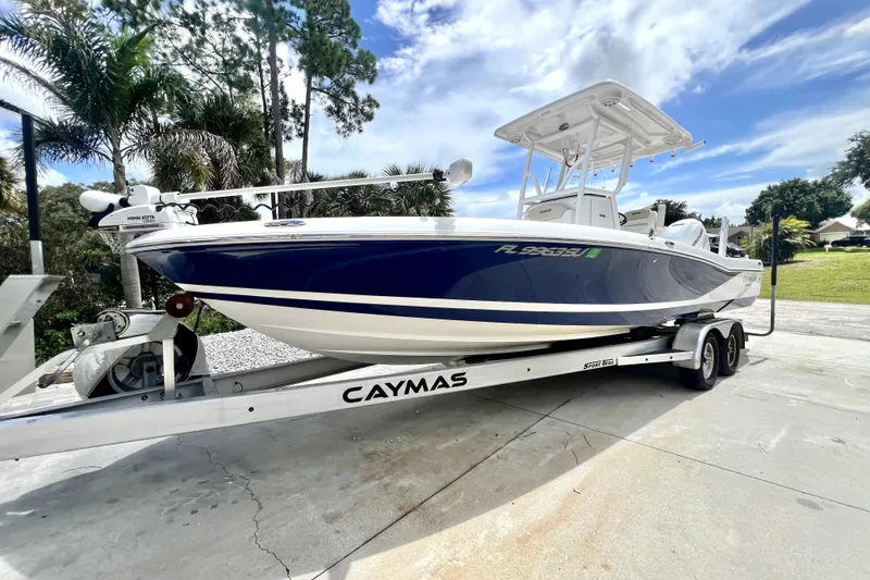 The Image of 2020 Caymas 26 HB boat on trailer, parked outdoors under a blue sky. - 0