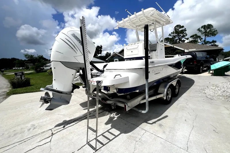 Slide: The Image of 2020 Caymas 26 HB boat with Mercury engine on trailer, parked outdoors. - 5