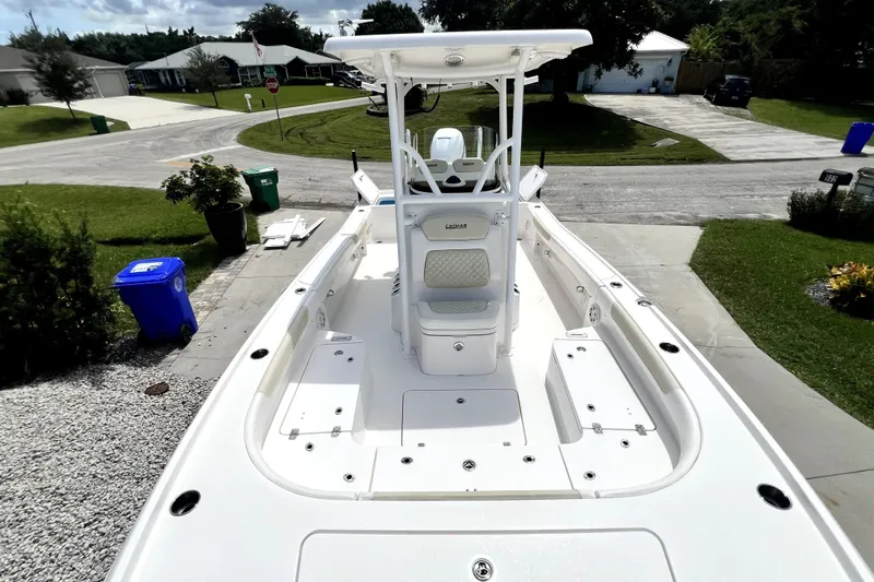 Slide: The Image of 2020 Caymas 26 HB boat on driveway, showcasing spacious deck and seating. - 58