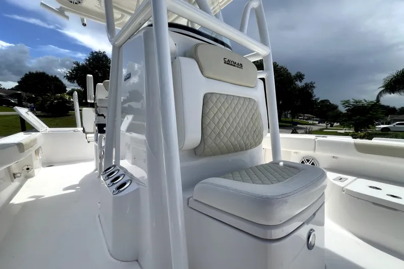 Slide: The Image of 2020 Caymas 26 HB boat interior with cushioned seating and sleek white design. - 48