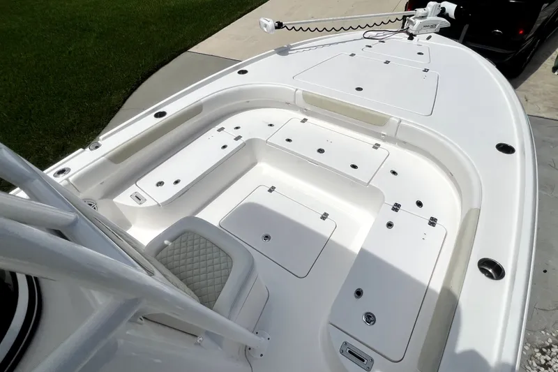 Slide: The Image of 2020 Caymas 26 HB boat deck with storage compartments and seating. - 54