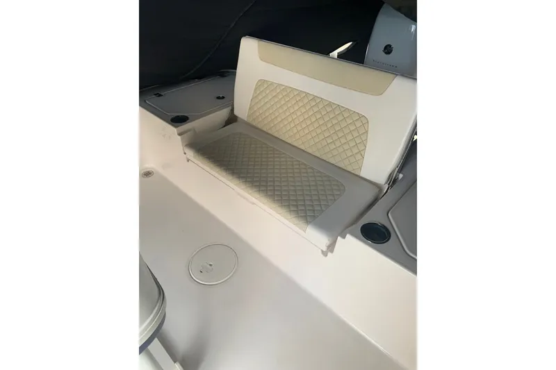 Slide: The Image of 2020 Caymas 26 HB boat interior with beige quilted seating. - 4