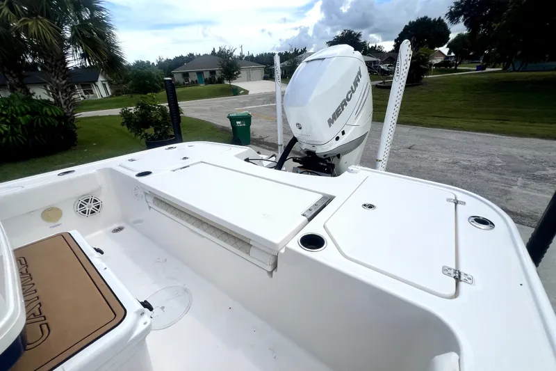 Slide: The Image of 2020 Caymas 26 HB boat with Mercury engine, parked in a residential area. - 84