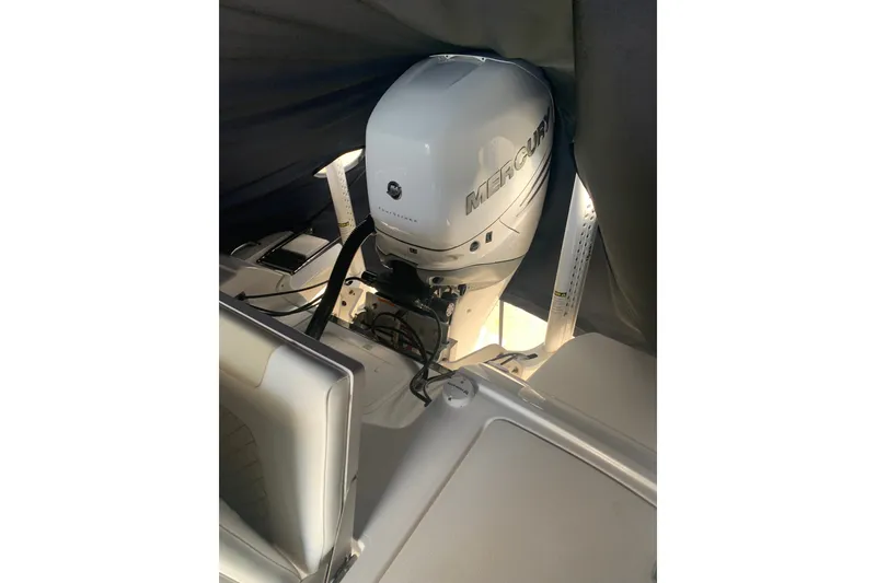 Slide: The Image of 2020 Caymas 26 HB boat with Mercury outboard engine, partially covered. - 8