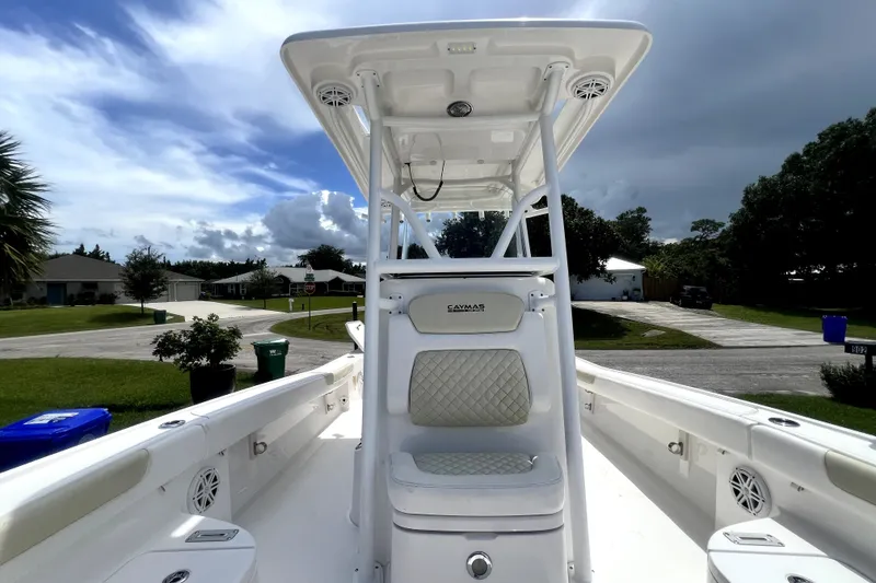 Slide: The Image of 2020 Caymas 26 HB boat interior with T-top and seating, parked in a residential area. - 51